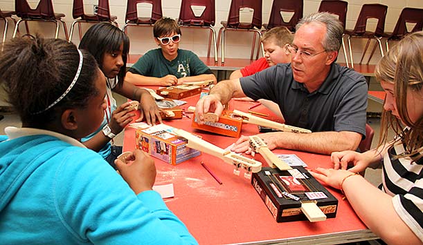 Mark Festa helping local elementary students learn the basics of string repair.
